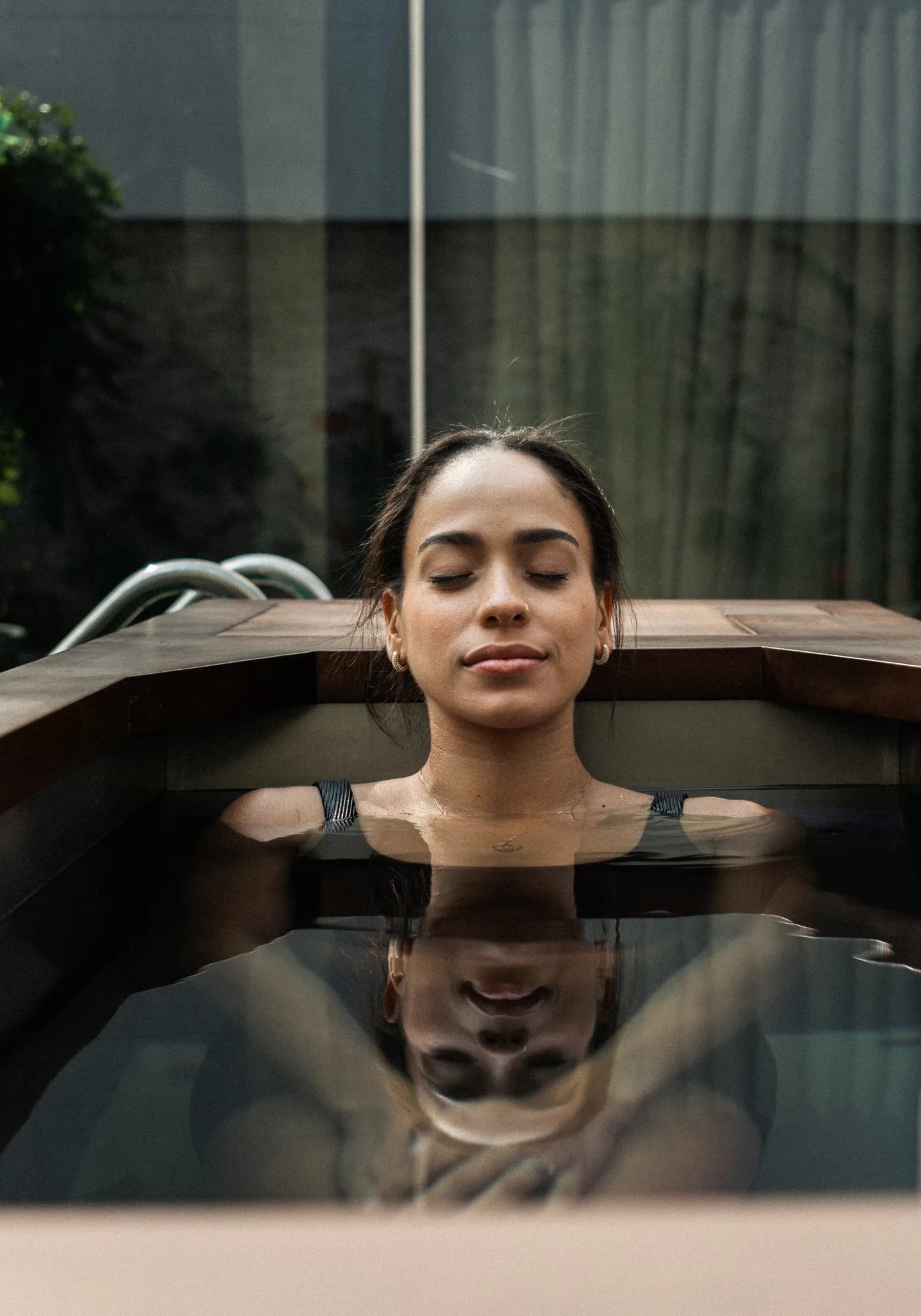 Seated in the cold plunge, water at shoulder height