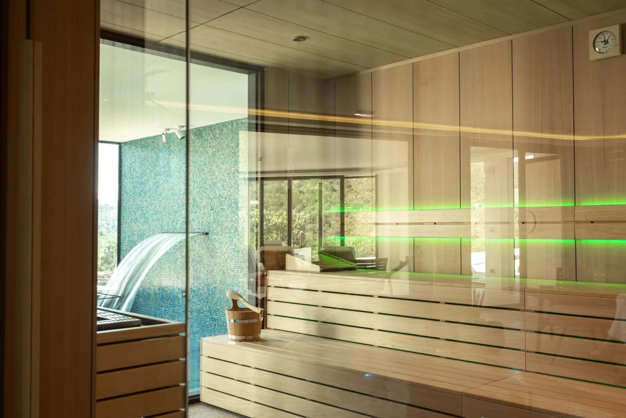 Home spa with sauna and plunge pool, garden beyond the glazing