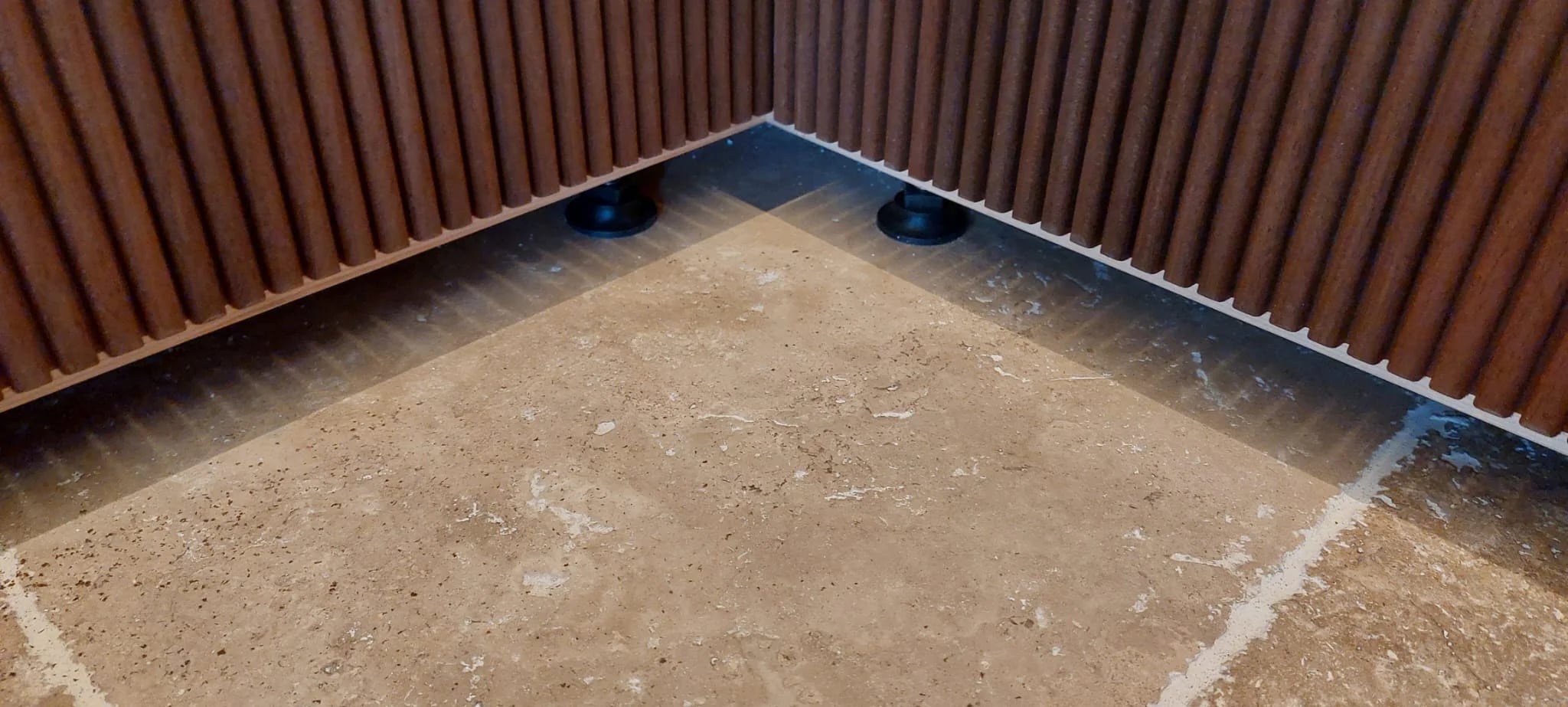 Floor and threshold detailing around an installed INFINITY sauna