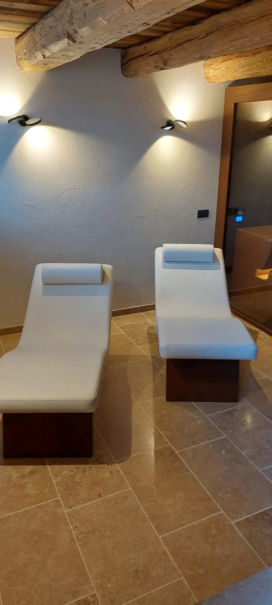 Relaxation loungers beside an INFINITY sauna installation