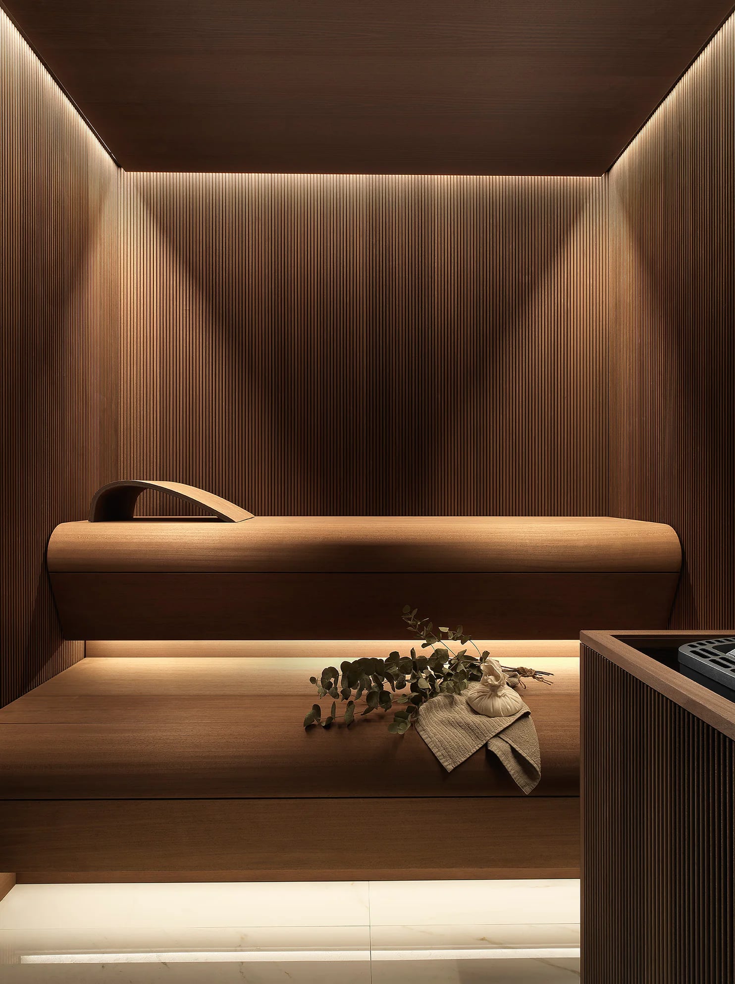 Dark timber INFINITY sauna with illuminated tiered benches