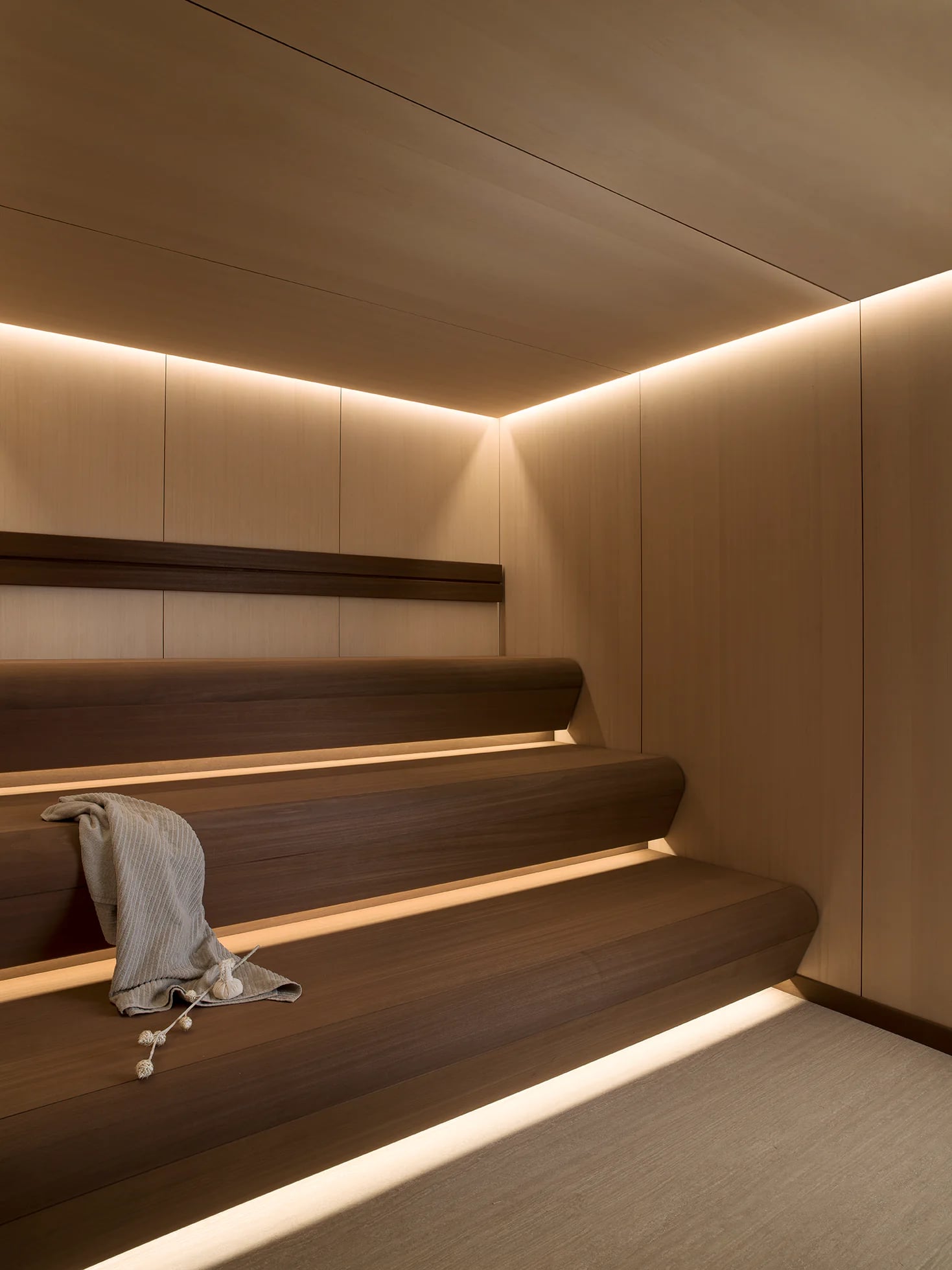 Angled view of light timber benches and perimeter lighting