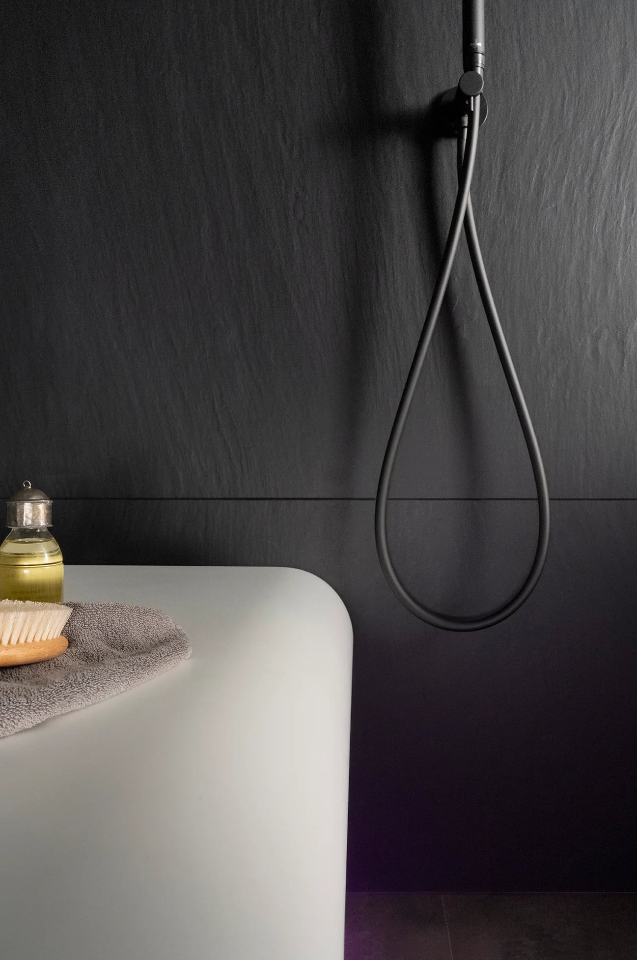 Dark-finished steam and shower room with a floating bench