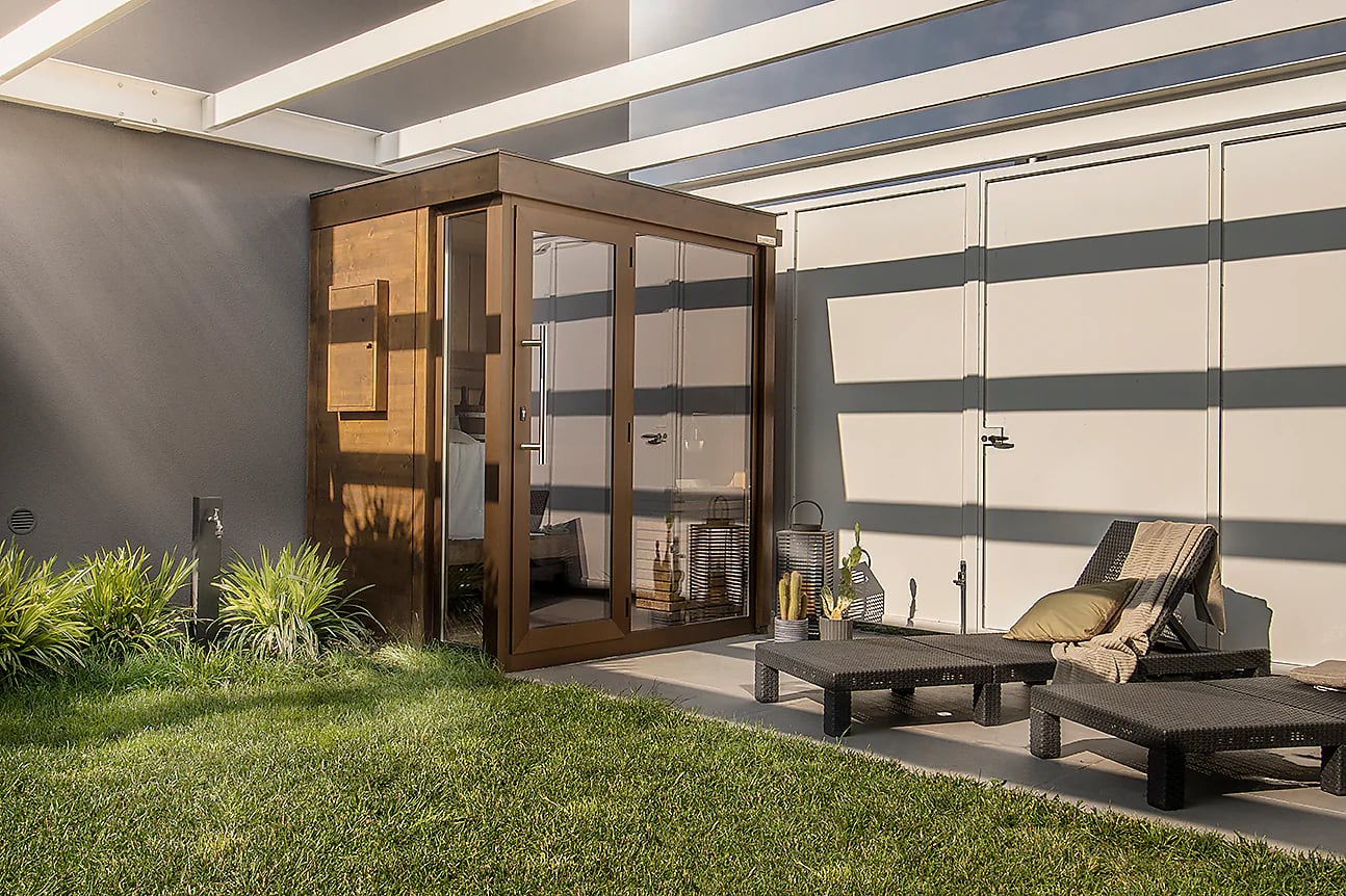 Compact glass-fronted sauna installed in a private garden