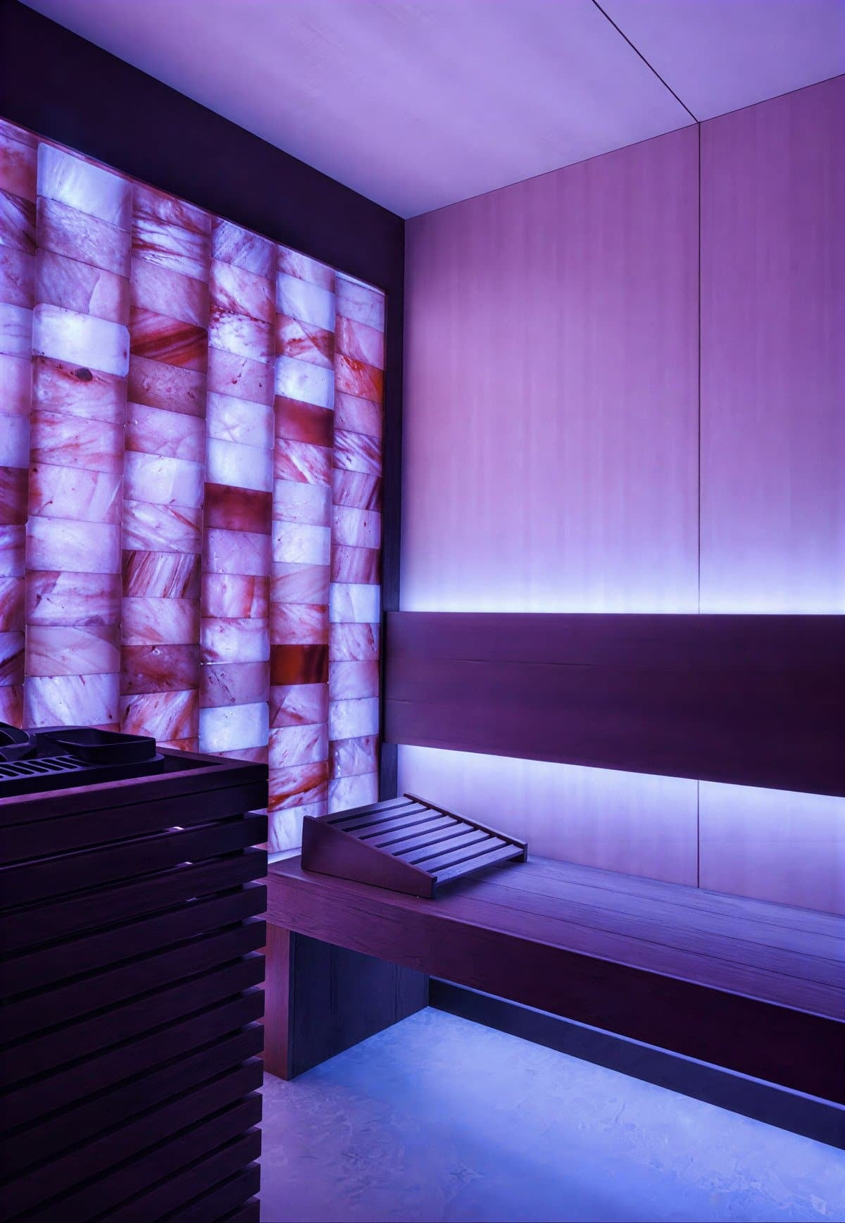 Salt sauna with backlit salt-brick wall and timber benching