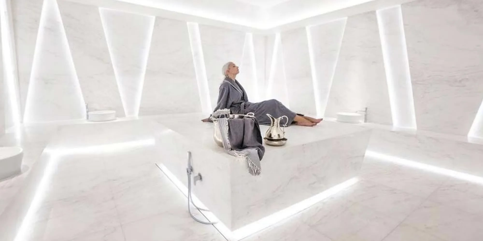 Turkish hammam with heated marble slab and recessed lighting