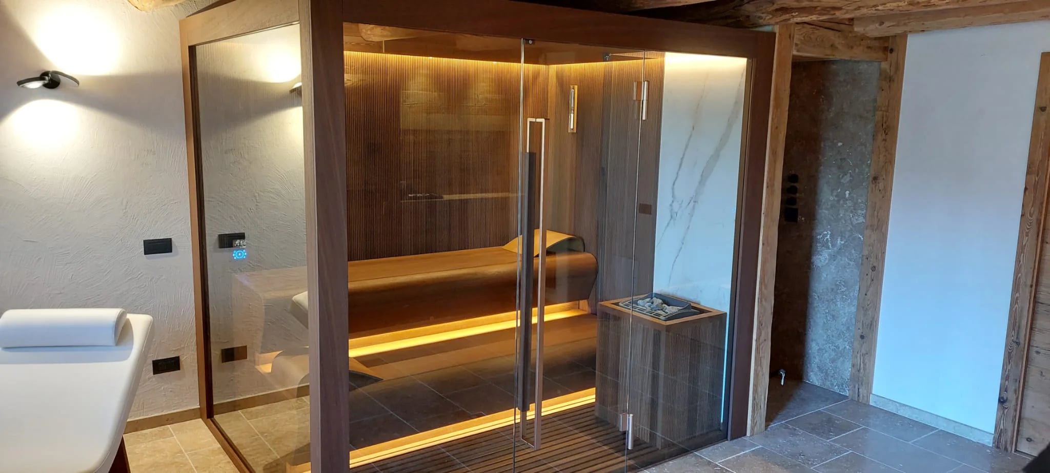 Glass-fronted INFINITY sauna in a completed private wellness room