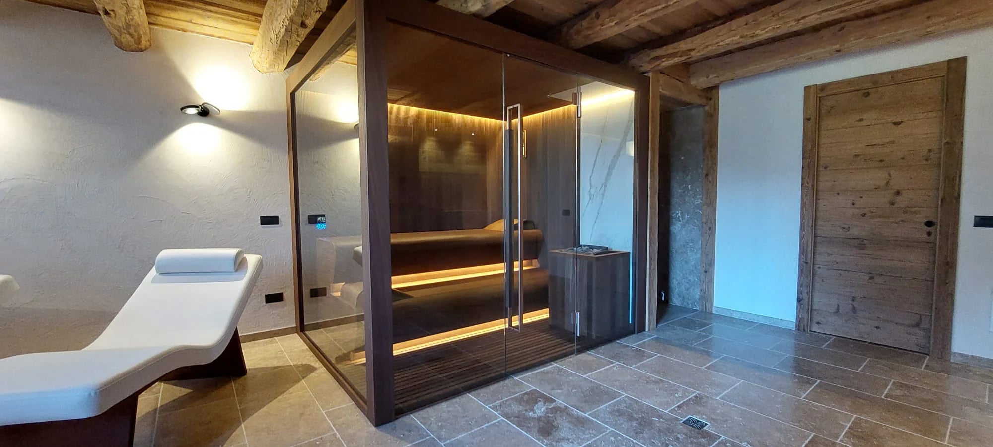 INFINITY sauna installed beside a relaxation area in a private wellness room