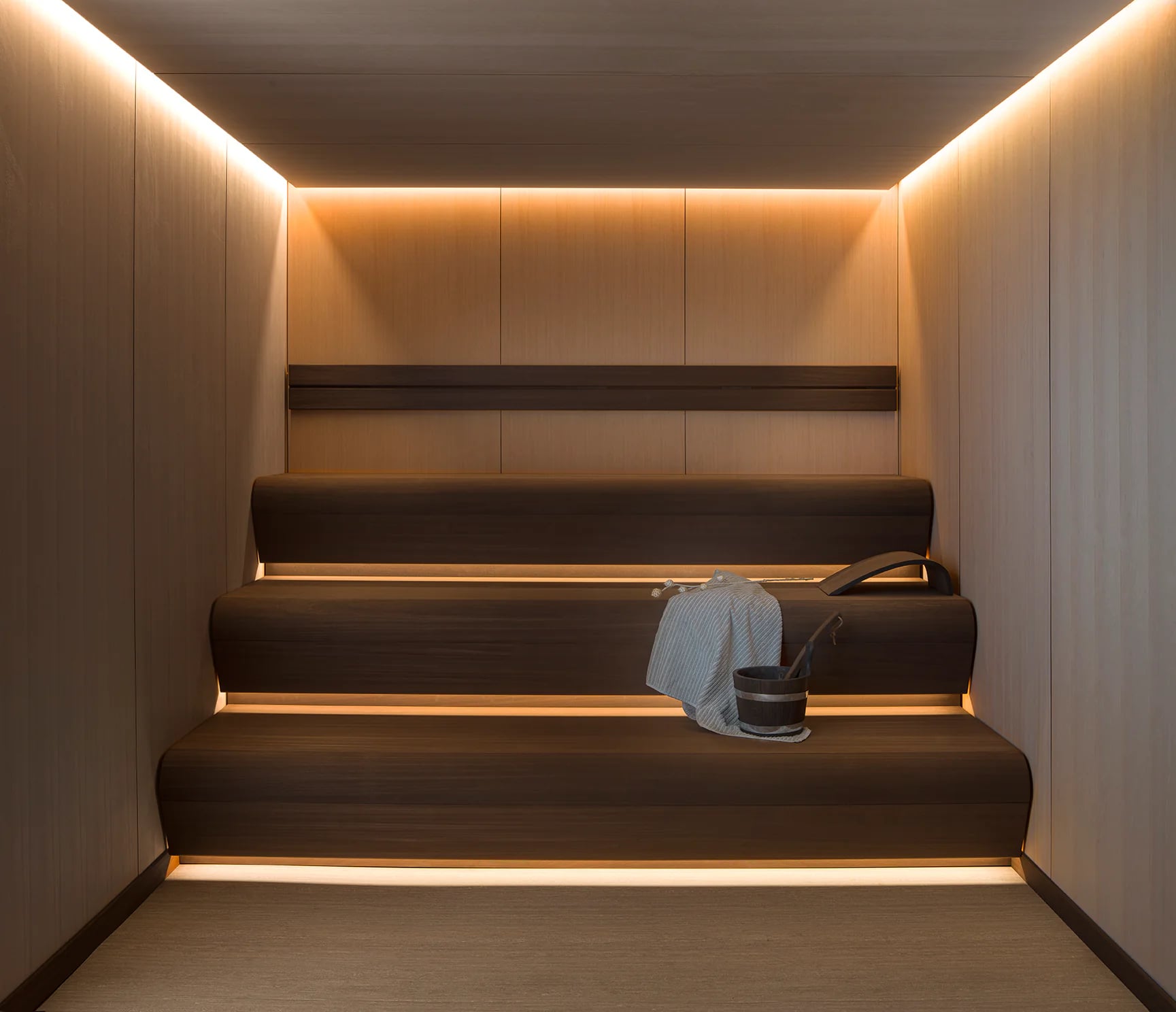 Warm timber sauna with softly illuminated benches