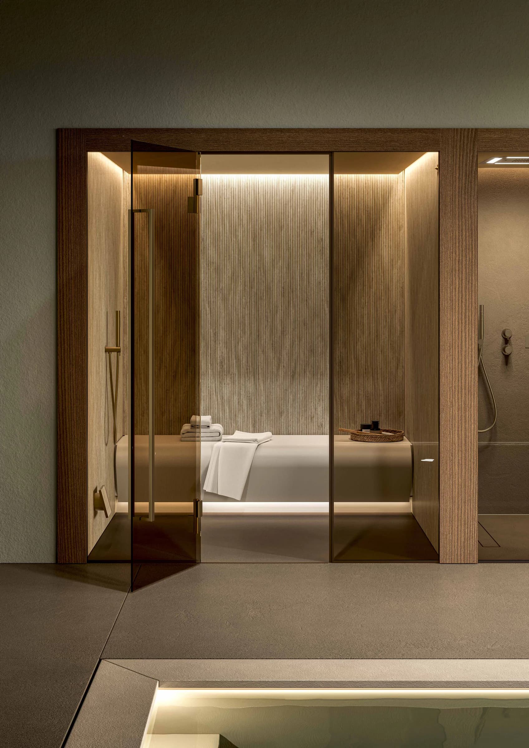 Glass-fronted INFINITY steam room beside an indoor pool