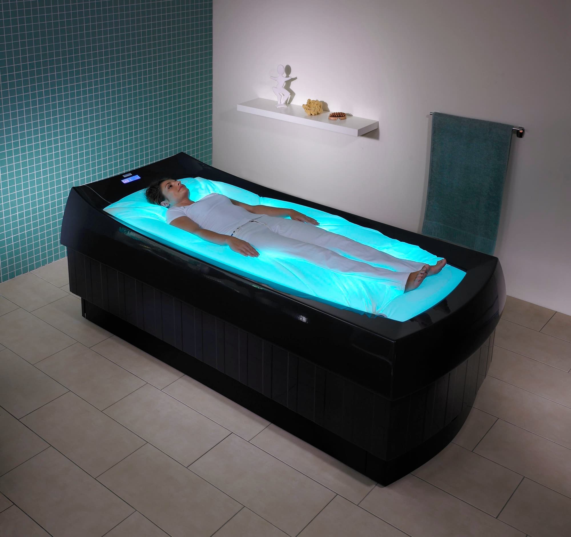 Dry flotation bed in use in a tiled spa room